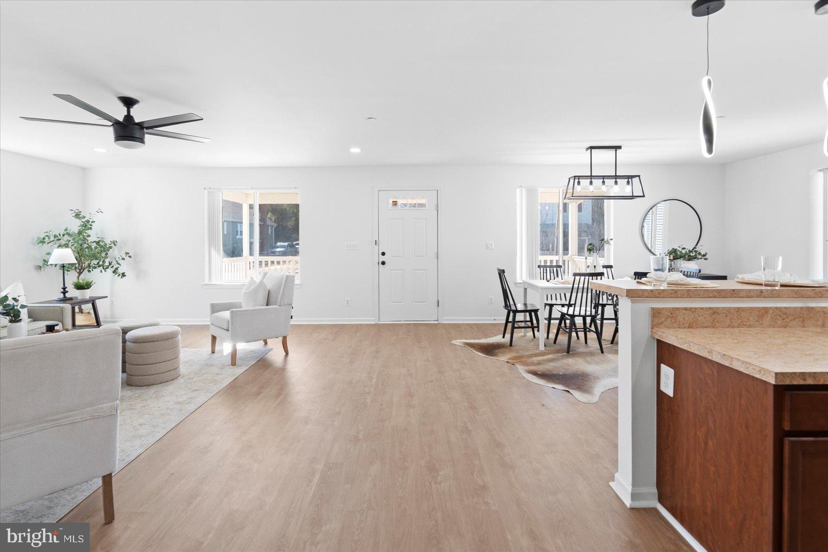 313 Homberg Avenue Baltimore, MD 21221 - Photo 28 of 47 a living room with furniture a dining table and a fireplace