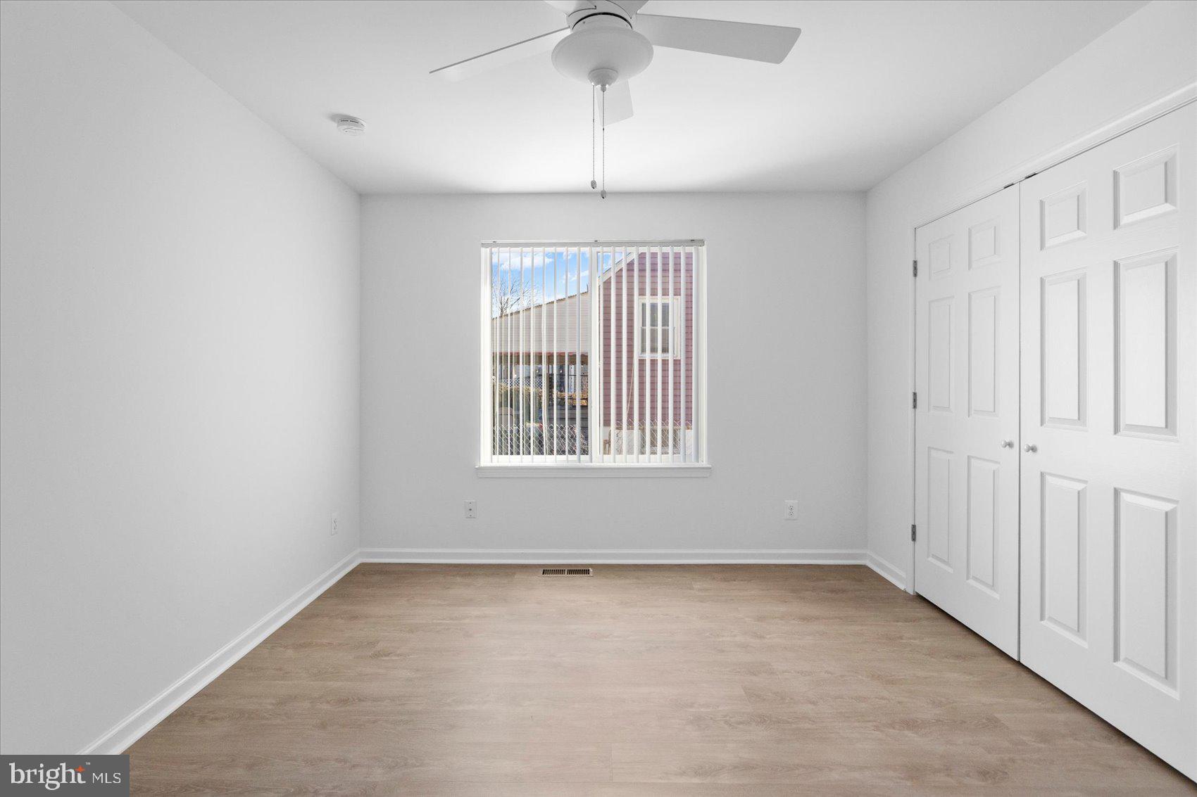 313 Homberg Avenue Baltimore, MD 21221 - Photo 29 of 47 an empty room with chandelier fan and windows