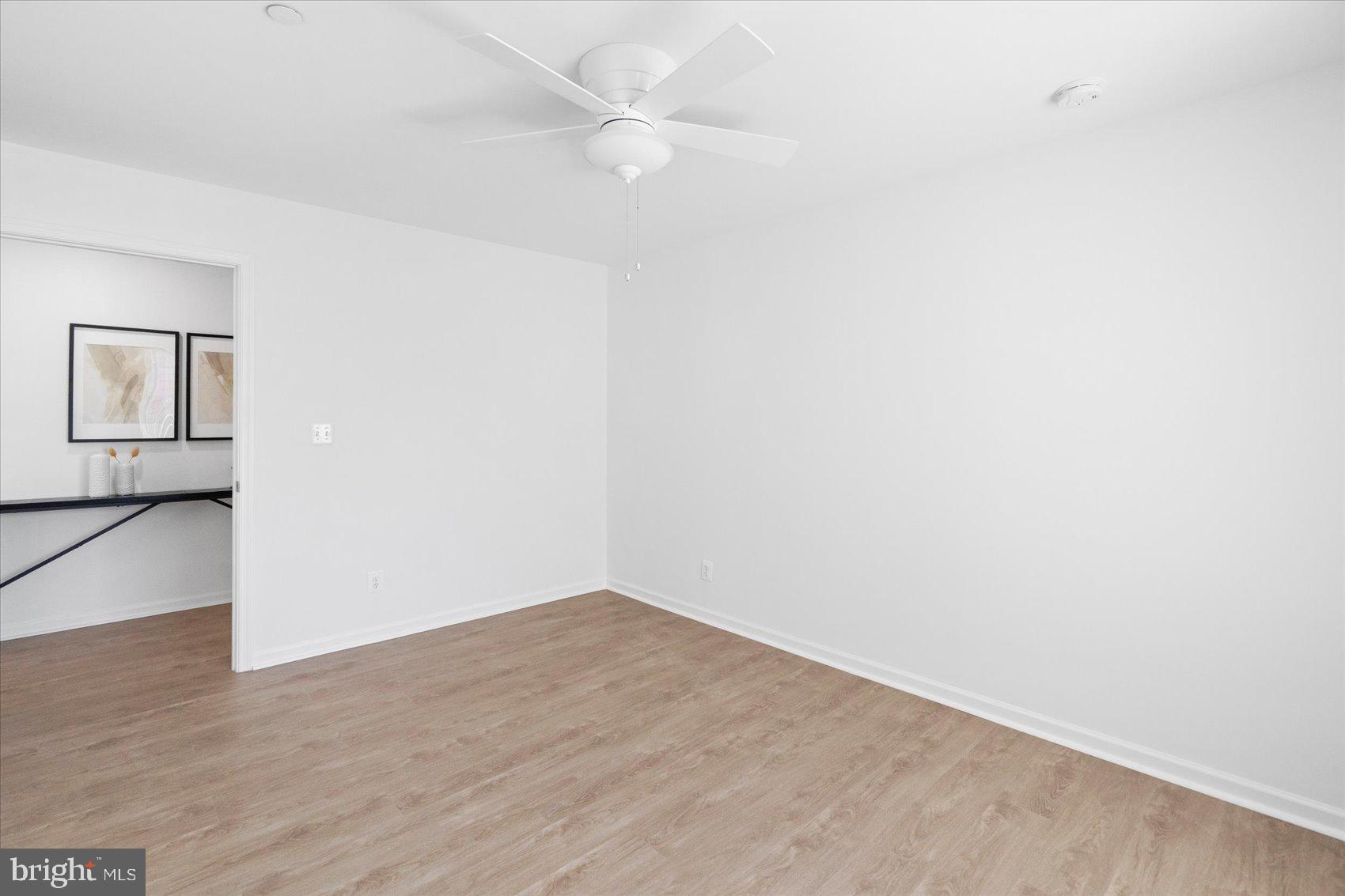 313 Homberg Avenue Baltimore, MD 21221 - Photo 30 of 47 an empty room with wooden floor and fan