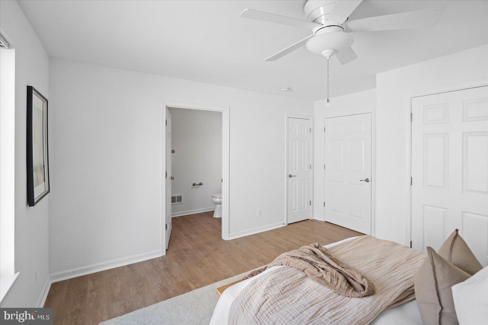 313 Homberg Avenue Baltimore, MD 21221 - Photo 34 of 47 a bedroom with a bed and a chandelier fan