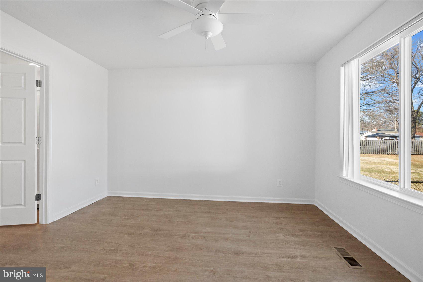 313 Homberg Avenue Baltimore, MD 21221 - Photo 43 of 47 wooden floor in an empty room with a window