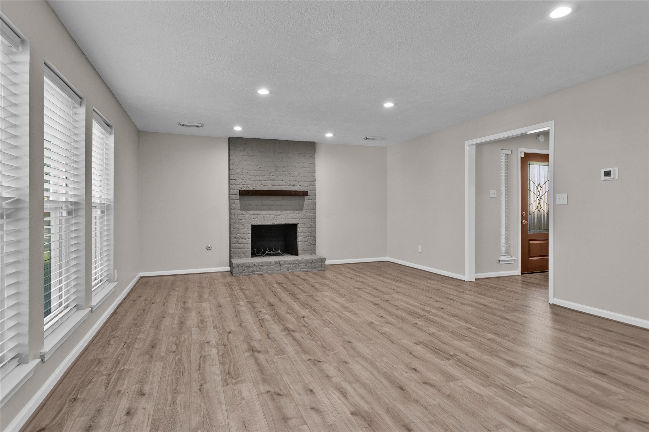 9115 Godstone Lane Spring, TX 77379 - Photo 5 of 46 The living room features a gas fireplace and tons of natural light.