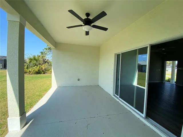 a view of a livingroom with a ceiling fan and window