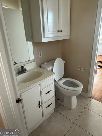 a bathroom with a toilet a sink and a window