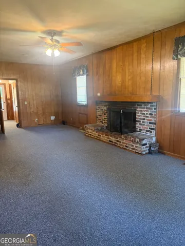 a view of an empty room with a fireplace