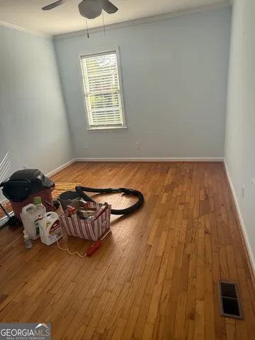 a room with wooden floor and furniture