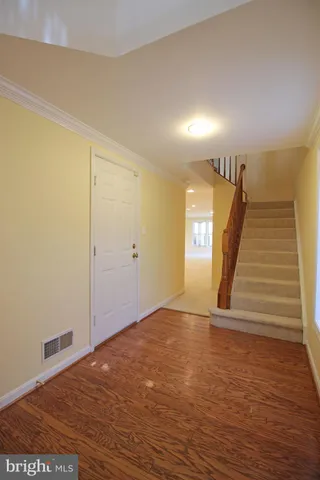 a view of an empty room and stairs