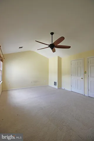 a view of a livingroom with a ceiling fan and window