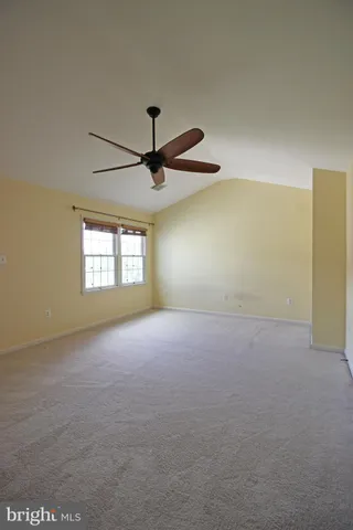 a view of a livingroom with a ceiling fan and window