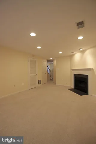 a view of empty room with a fireplace