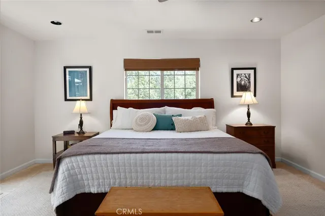 a bedroom with a bed and a window