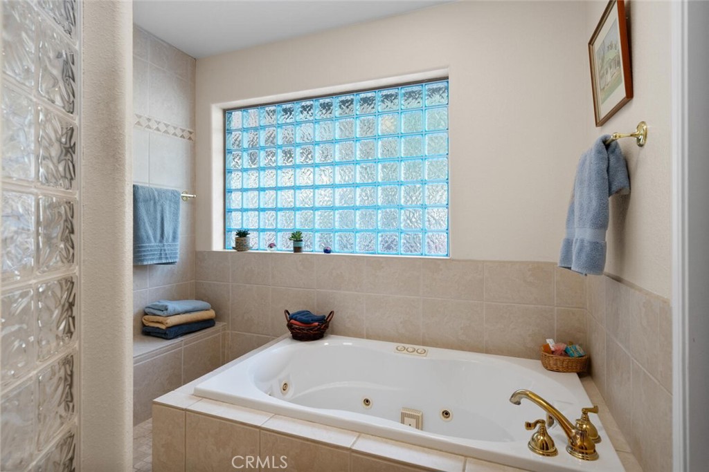 5056 Hooper Lane Chico, CA 95928 - Photo 23 of 57 a bathroom with a bathtub and a shower