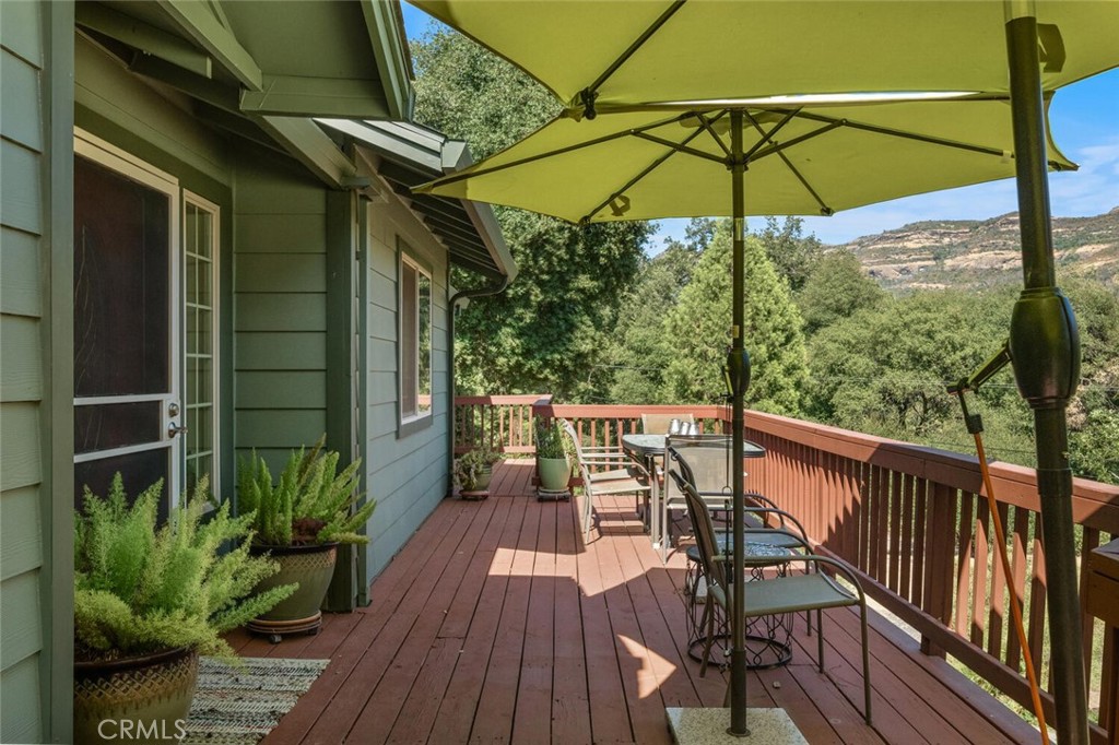 5056 Hooper Lane Chico, CA 95928 - Photo 4 of 57 a view of a balcony with table and chairs under an umbrella
