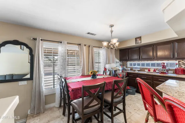 a view of a dining room with furniture and a chandelier