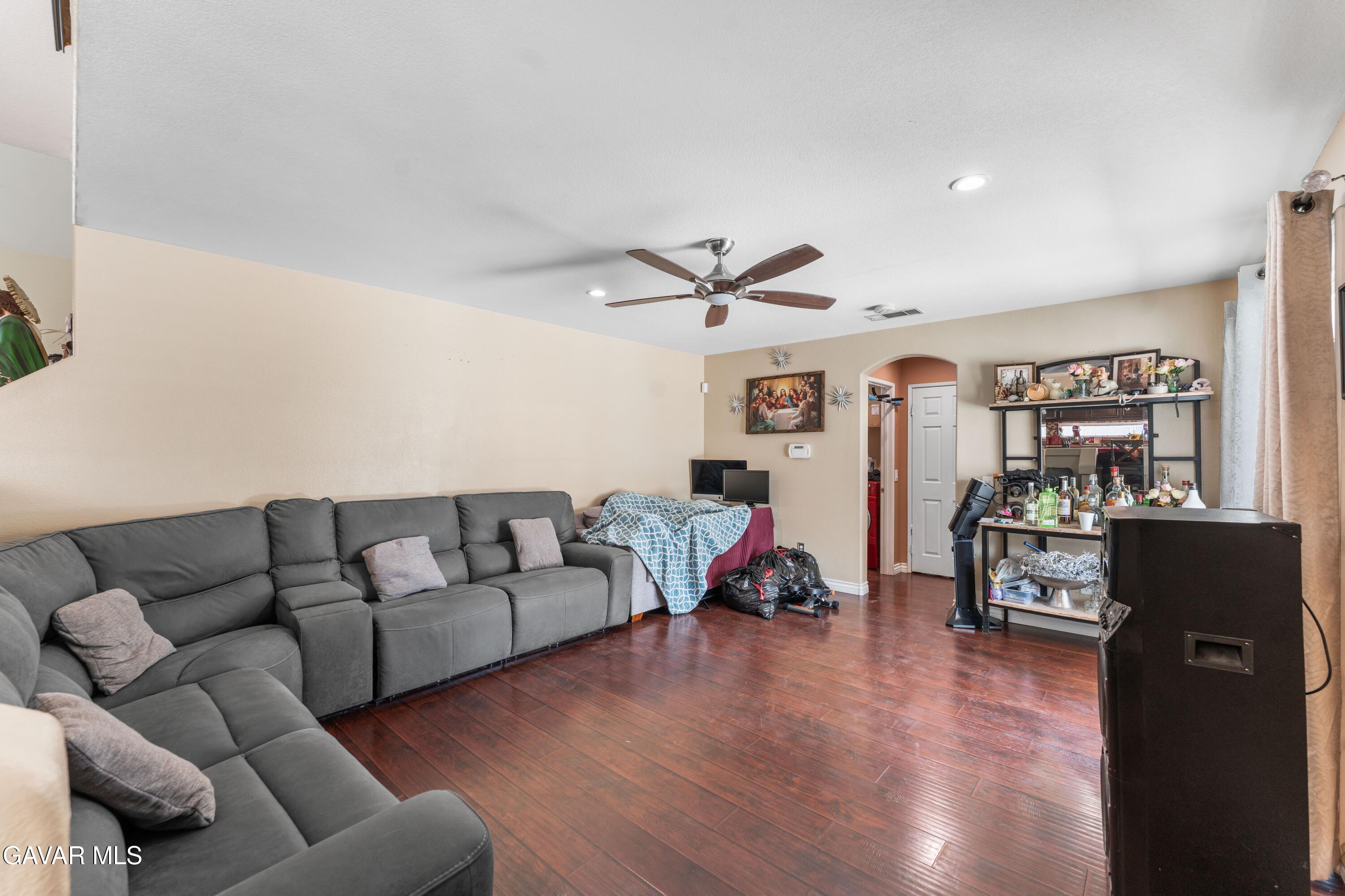 5602 East Ave R 11 Palmdale, CA 93552 - Photo 18 of 27 a living room with furniture and wooden floor