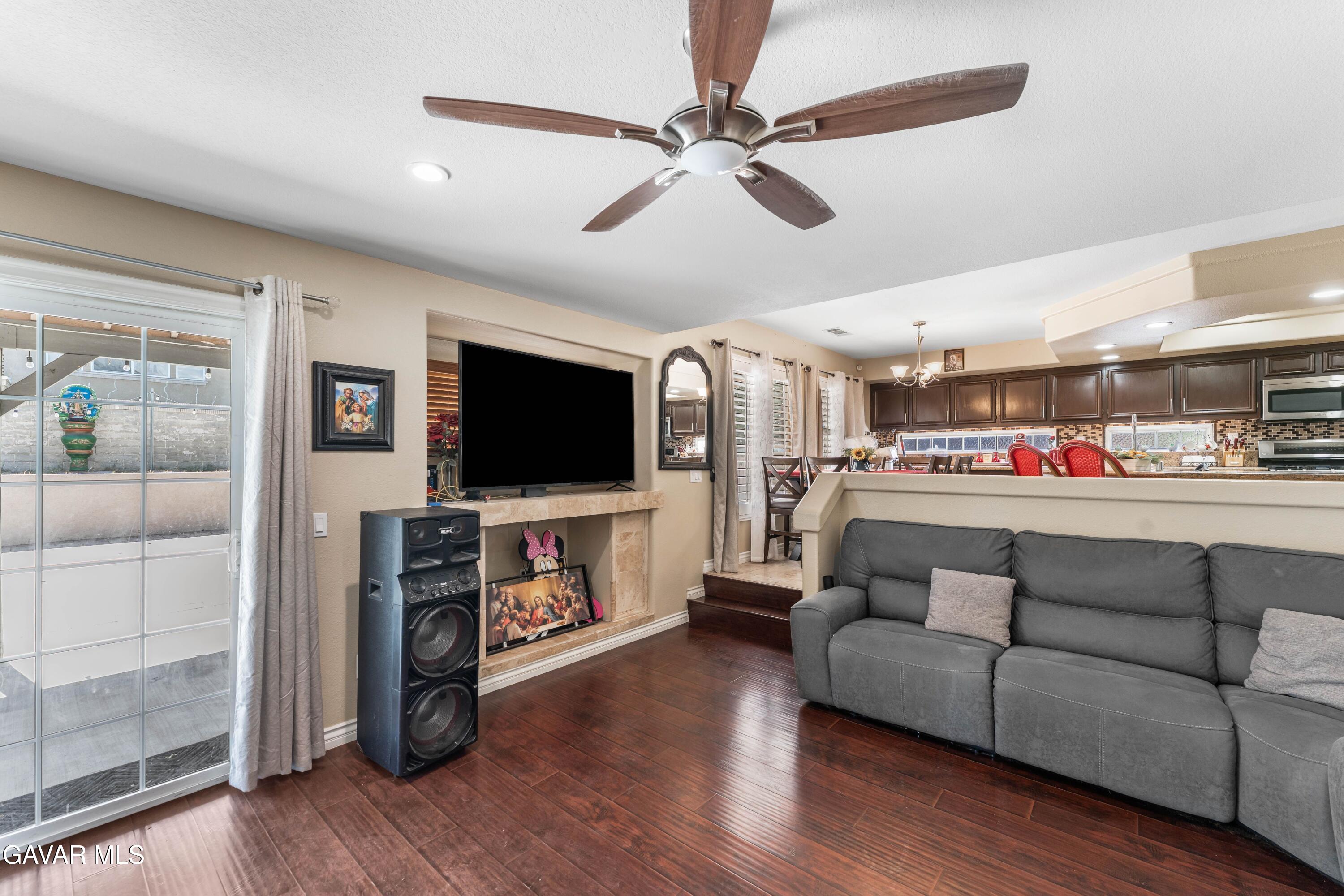 5602 East Ave R 11 Palmdale, CA 93552 - Photo 19 of 27 a living room with furniture and a flat screen tv