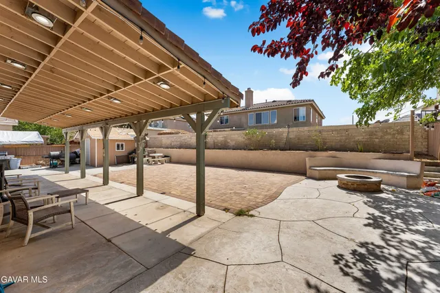 a backyard of a house with table and chairs