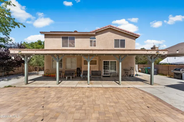 a backyard of a house with yard and outdoor seating