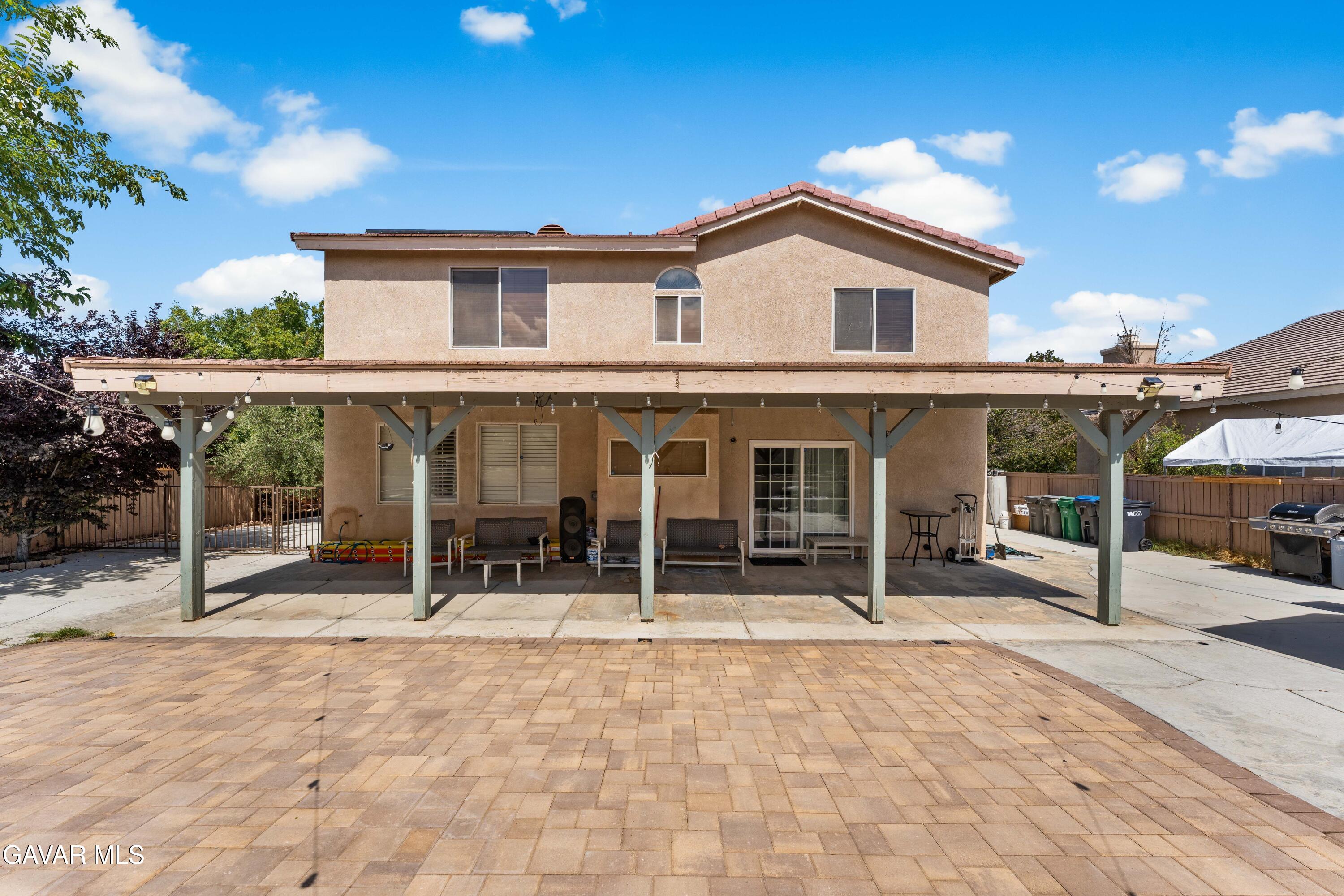 5602 East Ave R 11 Palmdale, CA 93552 - Photo 26 of 27 a backyard of a house with yard and outdoor seating