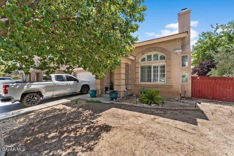 5602 East Ave R 11 Palmdale, CA 93552 - Photo 3 of 27 a front view of a house with a yard