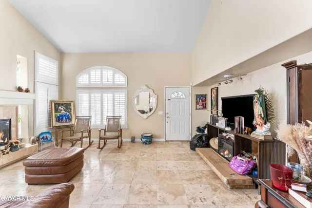 a living room with fireplace furniture and a flat screen tv