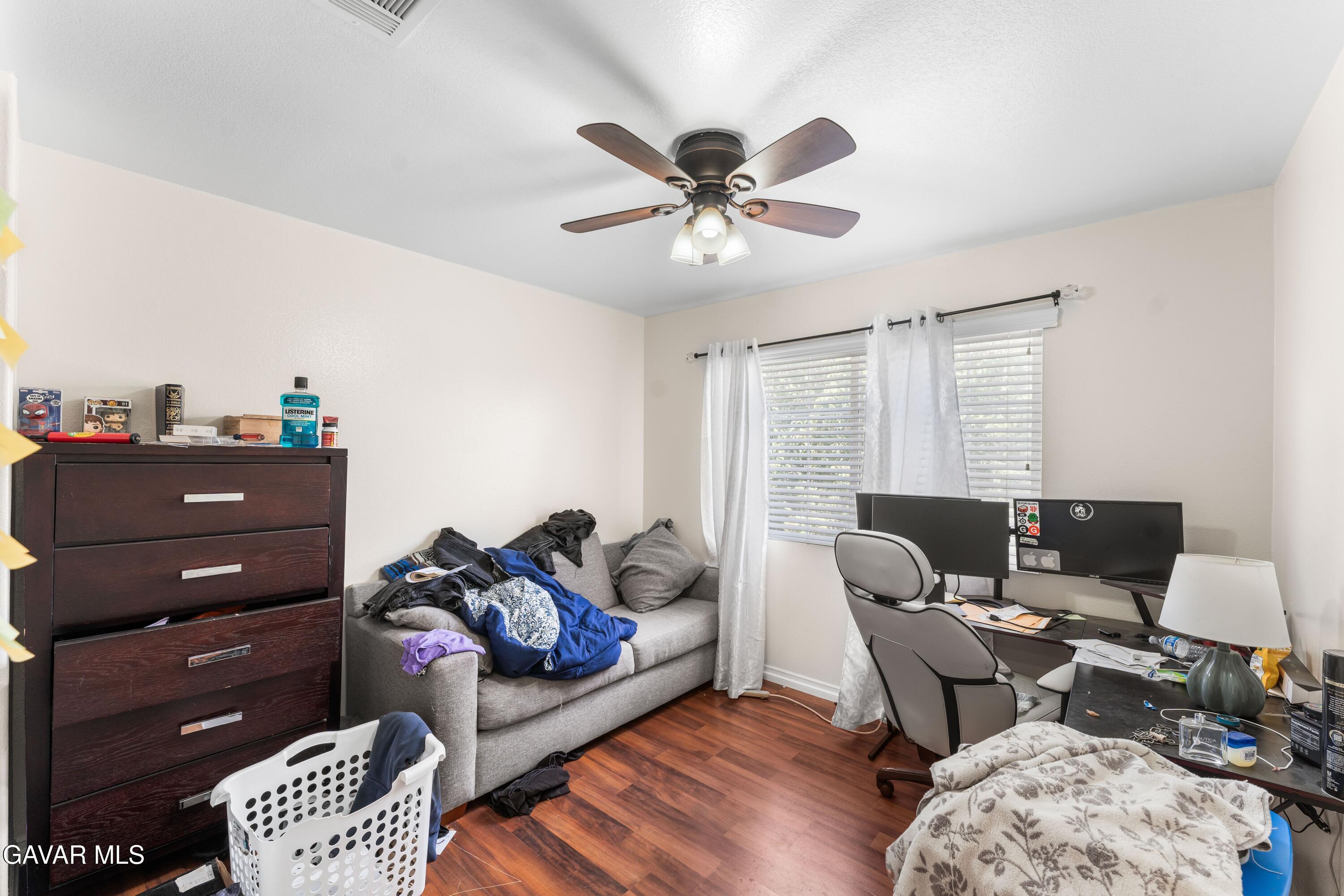 5602 East Ave R 11 Palmdale, CA 93552 - Photo 7 of 27 a living room with furniture and a window