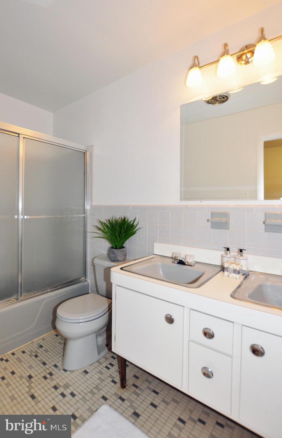 6901 Millwood Road Bethesda, MD 20817 - Photo 23 of 28 Upstairs Hall Bath with new lighting and mirror