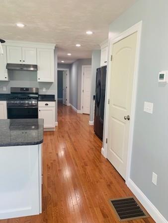 222 Reservoir Road Lunenburg, MA 01462 - Photo 16 of 35 a kitchen with stainless steel appliances a refrigerator and a stove top oven