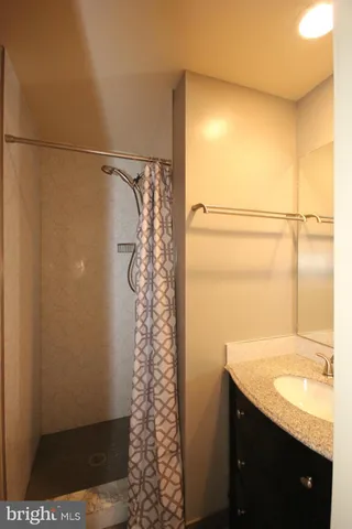 a bathroom with a shower curtain and a sink
