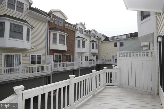 a view of a house with a wooden fence