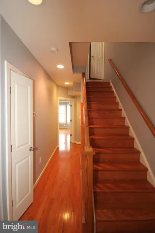 a view of entryway and hall with wooden floor