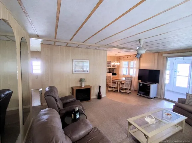 a living room with furniture and a mirror