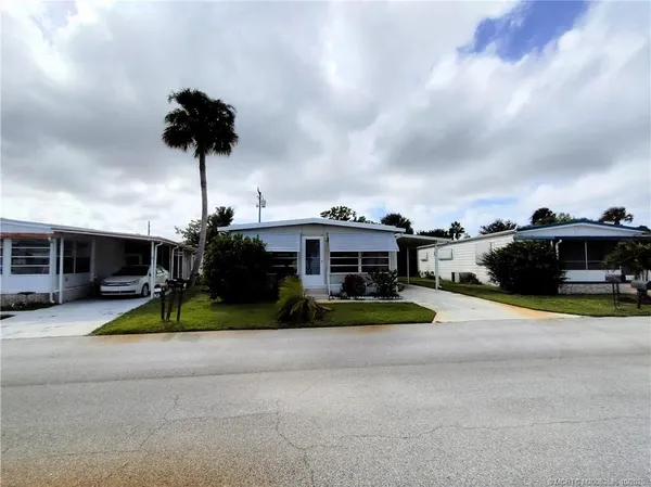 a view of a house with backyard and kitchen