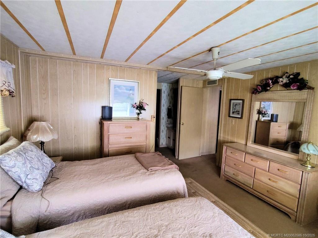 2540 Southeast Penny Lane Stuart, FL 34994 - Photo 23 of 62 a bedroom with a bed and furniture