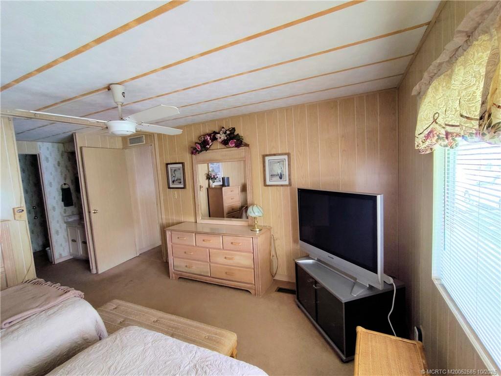 2540 Southeast Penny Lane Stuart, FL 34994 - Photo 25 of 62 a living room with furniture and a flat screen tv