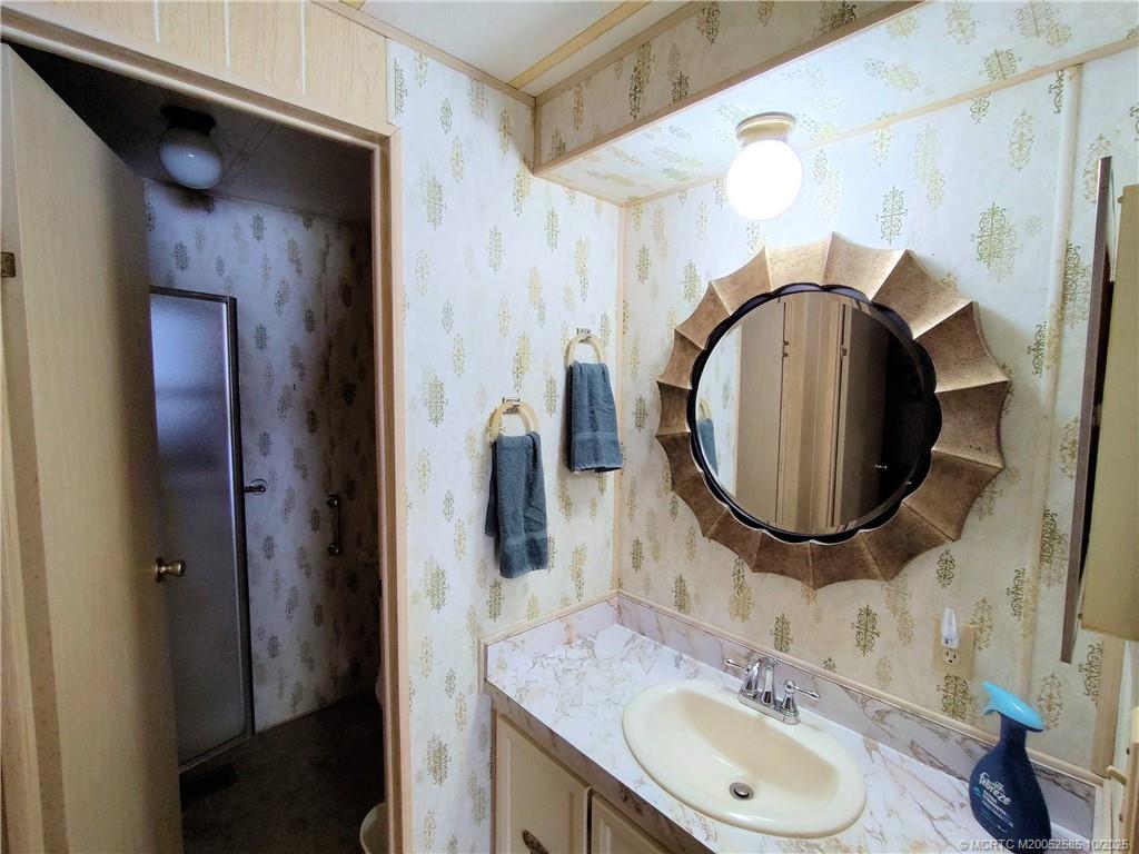 2540 Southeast Penny Lane Stuart, FL 34994 - Photo 28 of 62 a bathroom with a sink and a mirror