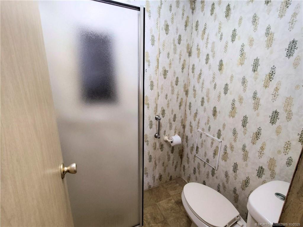 2540 Southeast Penny Lane Stuart, FL 34994 - Photo 29 of 62 a bathroom with a toilet and a shower