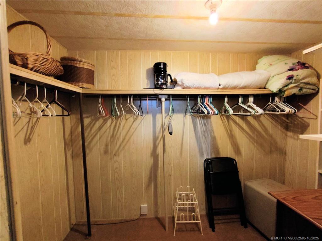 2540 Southeast Penny Lane Stuart, FL 34994 - Photo 33 of 62 a view of walk in closet with clothes and shoes