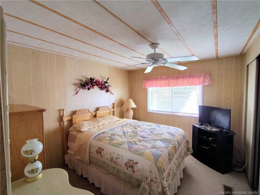2540 Southeast Penny Lane Stuart, FL 34994 - Photo 34 of 62 a bedroom with a bed and a window
