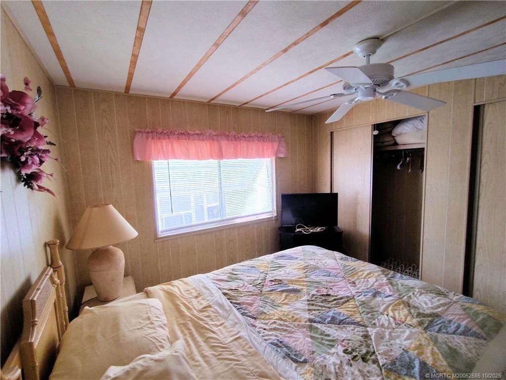 2540 Southeast Penny Lane Stuart, FL 34994 - Photo 36 of 62 a bedroom with a bed dresser and a window