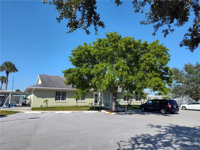a kitchen with stainless steel appliances granite countertop a sink a stove and refrigerator