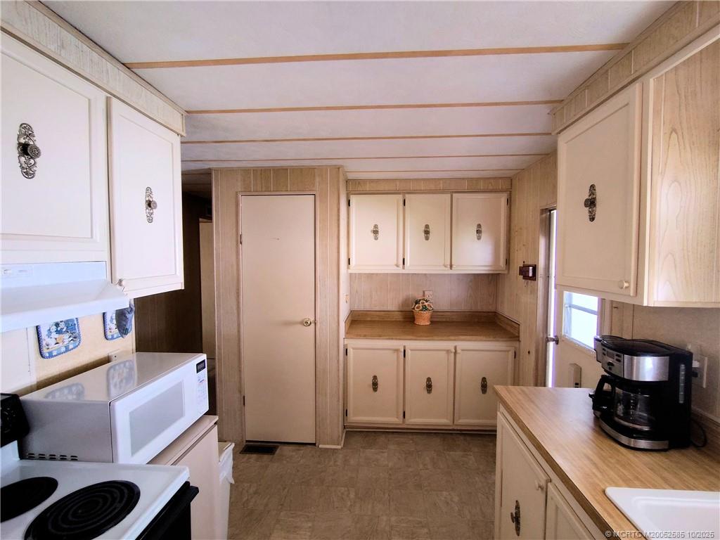2540 Southeast Penny Lane Stuart, FL 34994 - Photo 5 of 62 a kitchen with stainless steel appliances granite countertop a refrigerator and a stove top oven