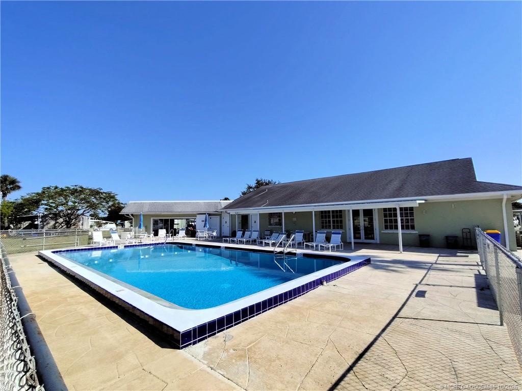2540 Southeast Penny Lane Stuart, FL 34994 - Photo 51 of 62 a view of swimming pool with outdoor seating and house in the background