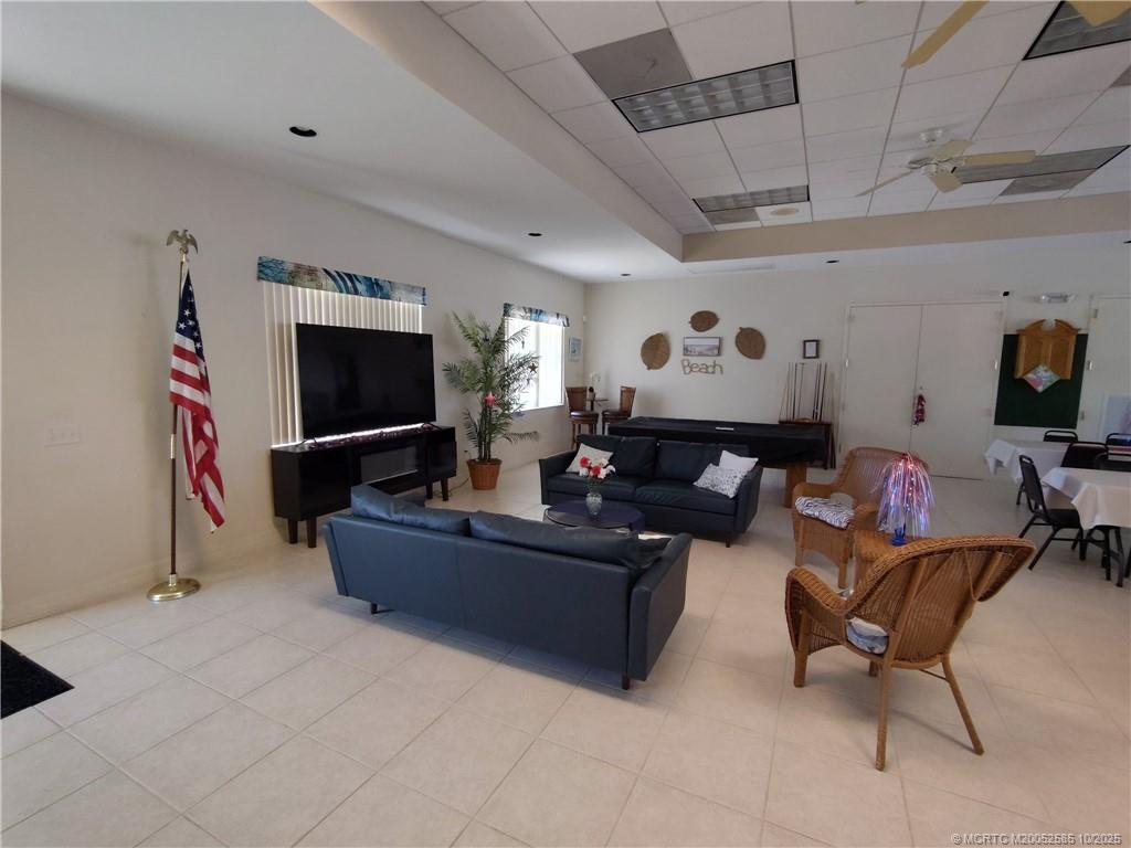 2540 Southeast Penny Lane Stuart, FL 34994 - Photo 60 of 62 a living room with furniture and a flat screen tv