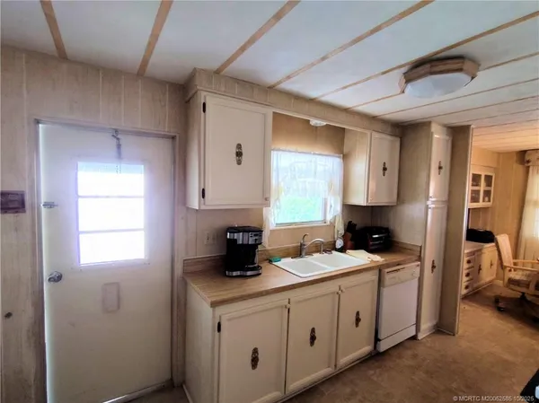 a kitchen with sink a cabinets and appliances