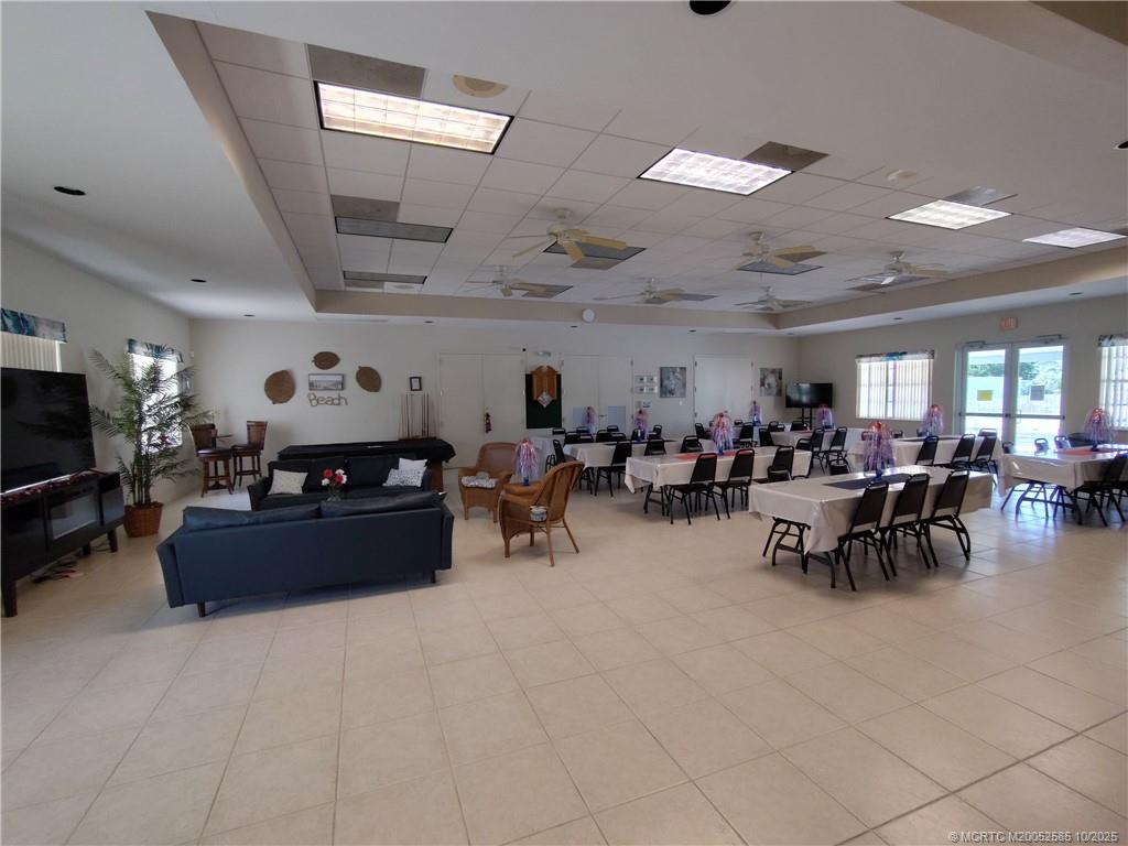 2540 Southeast Penny Lane Stuart, FL 34994 - Photo 61 of 62 a living room with lots of furniture and a flat screen tv