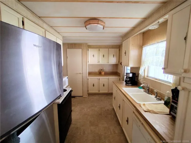 a kitchen with stainless steel appliances a sink stove and cabinets