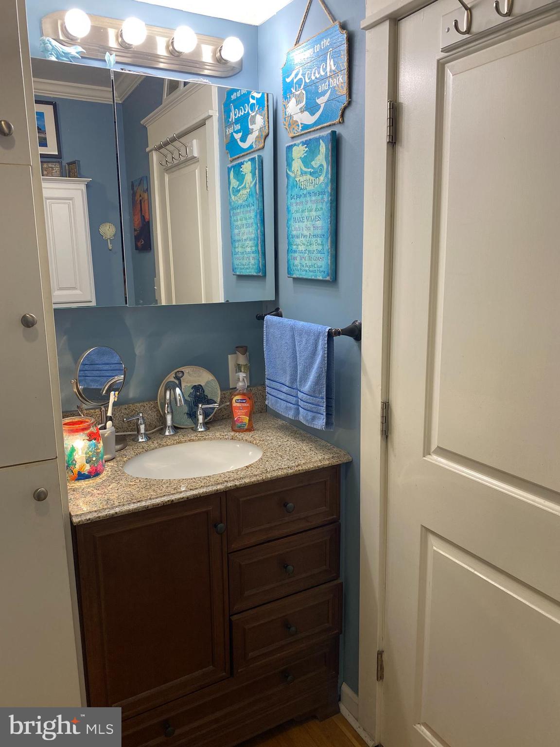 2419 Newcombtown Road Millville, NJ 08332 - Photo 16 of 34 a bathroom with a sink and a mirror