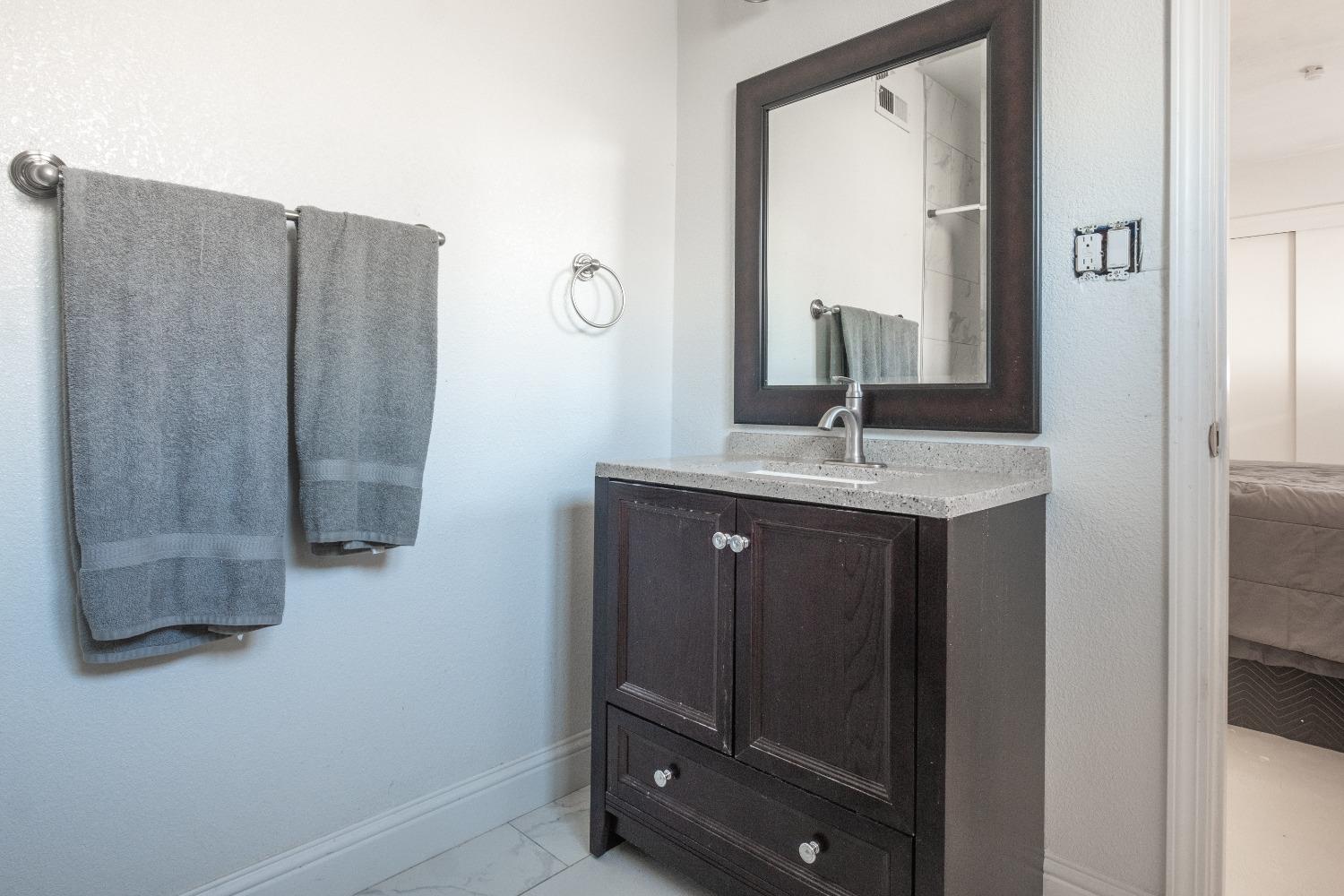 172 West Swift Avenue Clovis, CA 93612 - Photo 12 of 22 a bathroom with a sink and a mirror