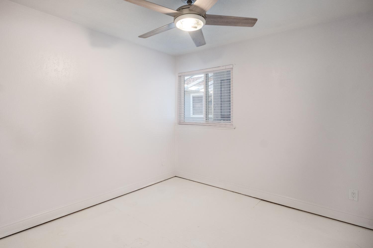 172 West Swift Avenue Clovis, CA 93612 - Photo 16 of 22 an empty room with a window and a fan
